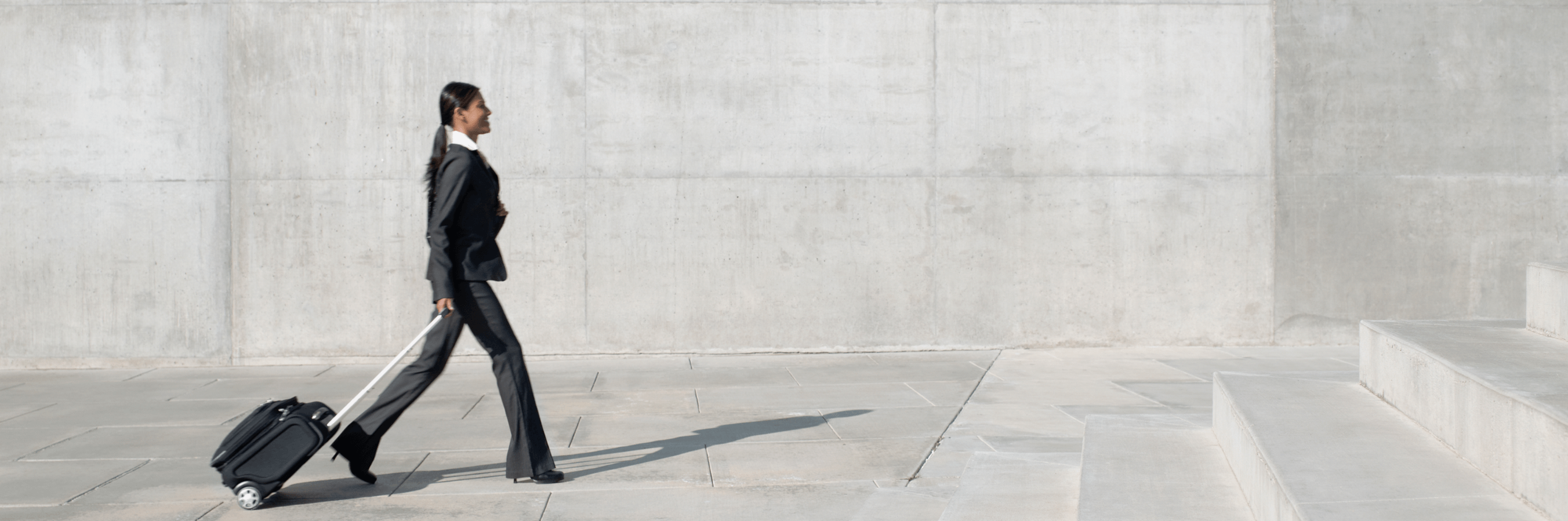 A woman traveling with a suitcase, representing WTS Global’s global mobility services